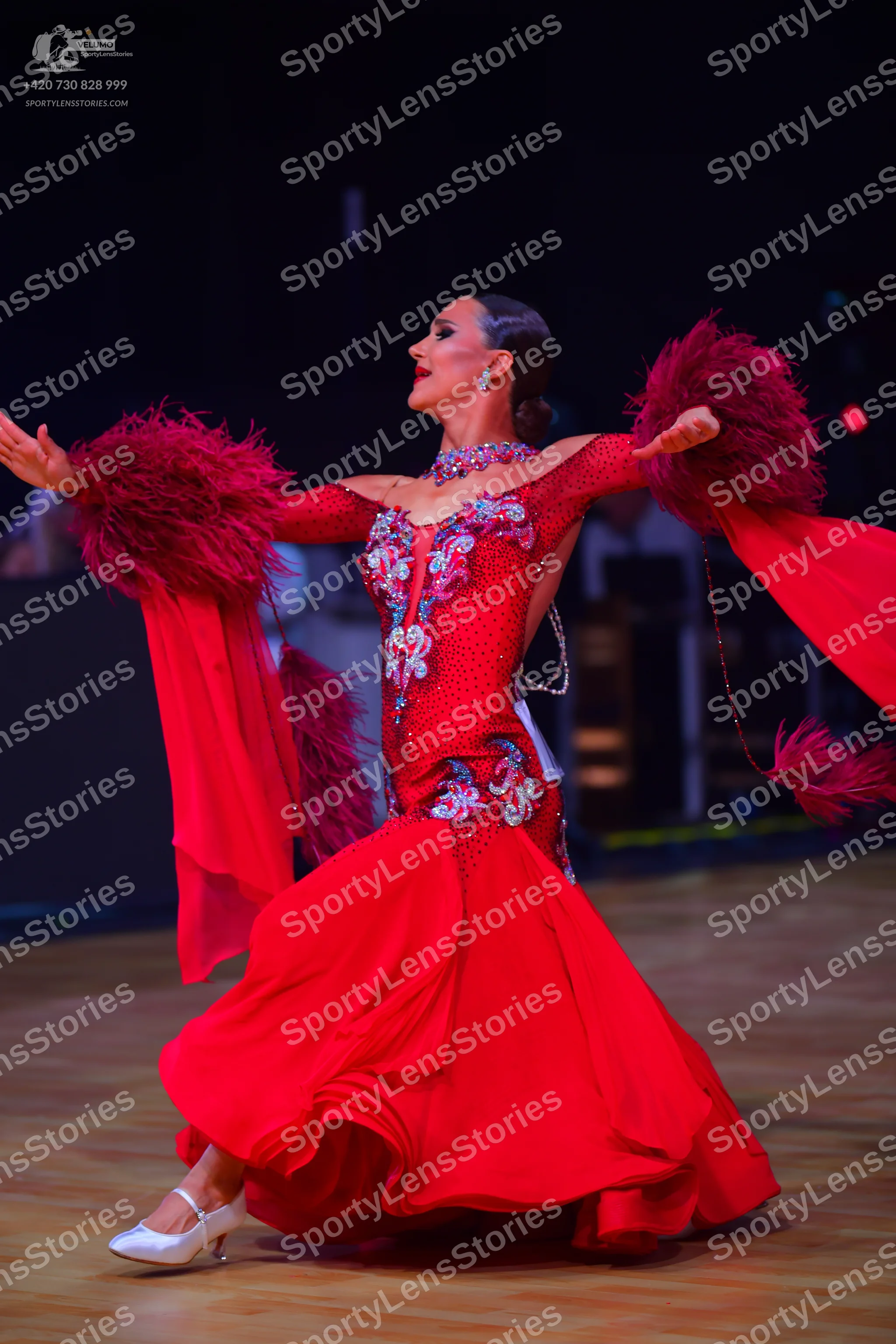 Dancesport competitor: Female dancer: red ballroom gown with a crystal-embellished bodice, long flowing