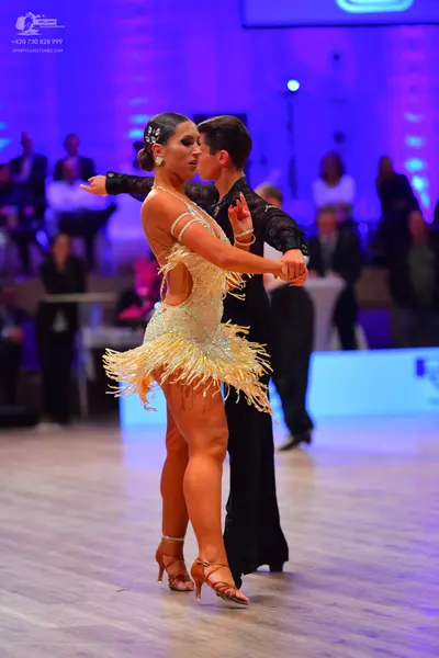 Dancesport competitor: Female dancer: champagne-colored Latin dress with fringe and sequins