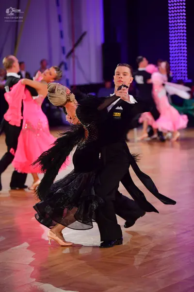 Dancesport competitor: Male dancer: black suit with white shirt