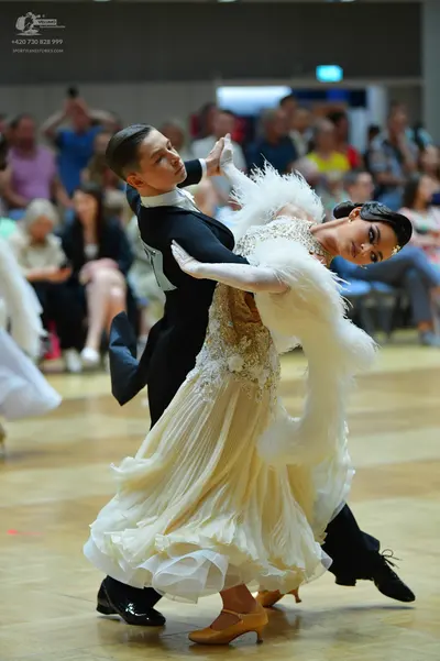Dancesport competitor: Male dancer: black tailcoat with white lapels, white shirt, and black trousers