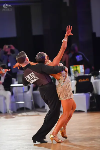 Dancesport competitor #440: Male dancer: black long-sleeved shirt and black trousers