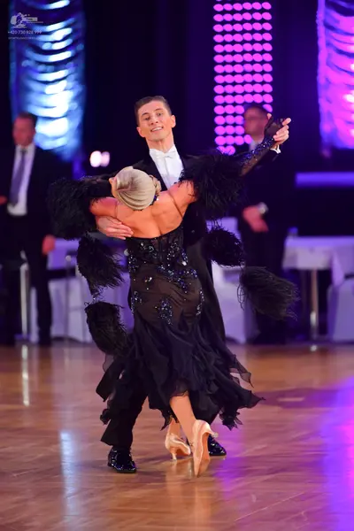 Dancesport competitor: Male dancer: black suit with a white shirt and a white bowtie