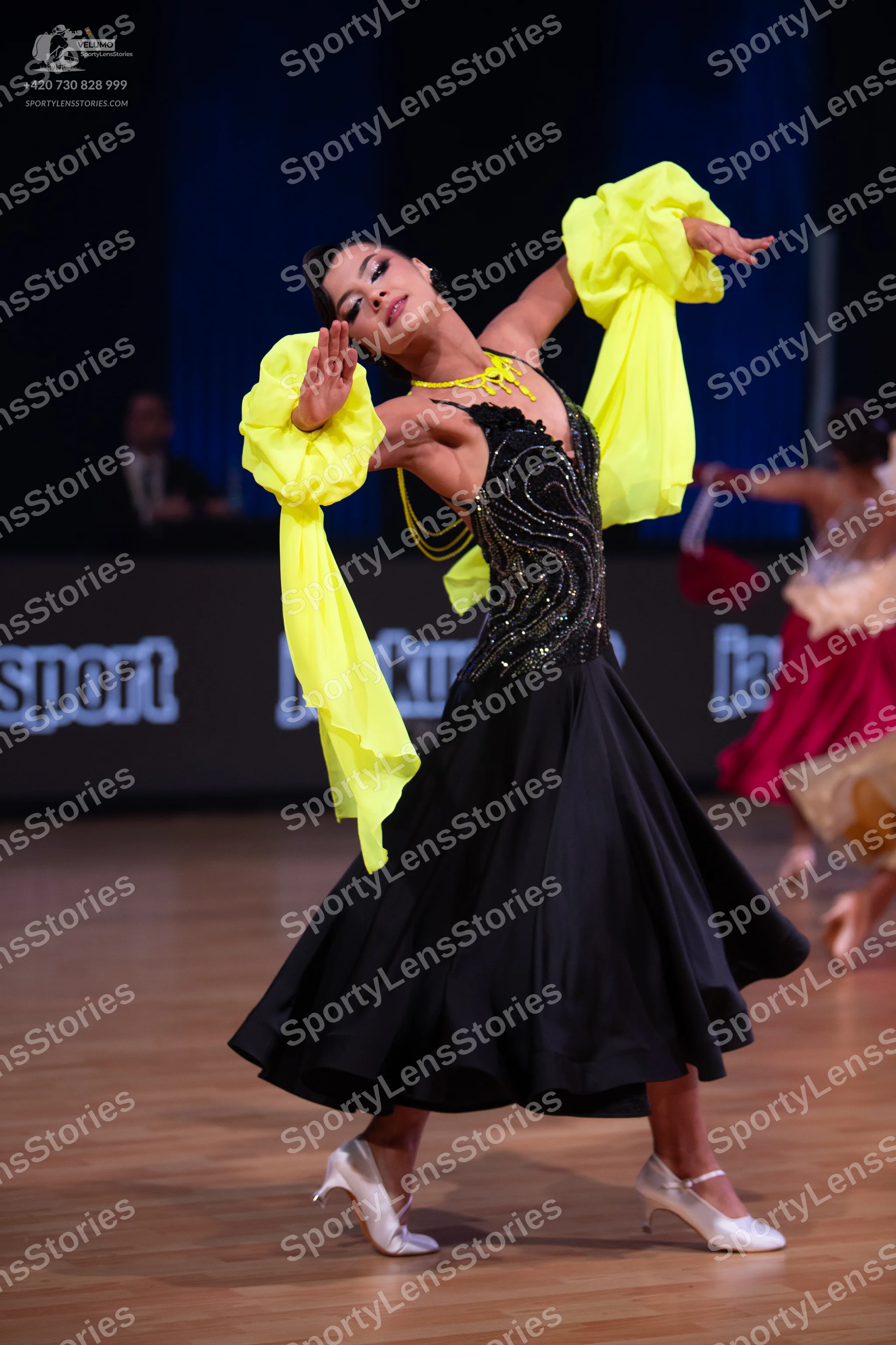 Dancesport competitor: Female dancer: black ballroom dress with a sequin-embellished bodice and a full