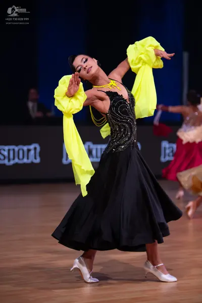 Dancesport competitor: Female dancer: black ballroom dress with a sequin-embellished bodice and a full 