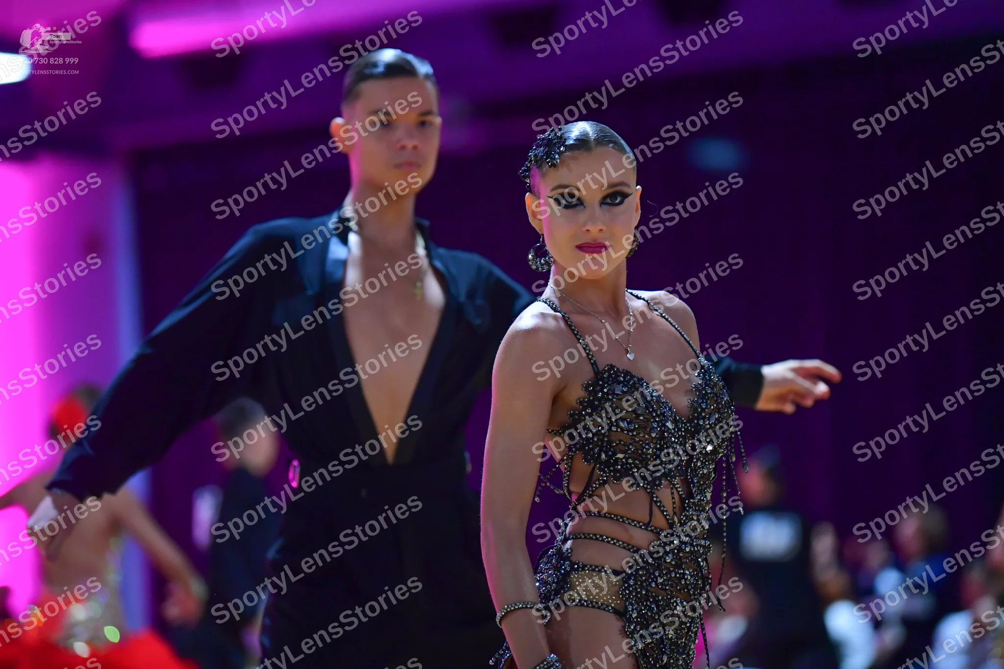 Dancesport competitor: Male dancer: black suit with a deep V-neck