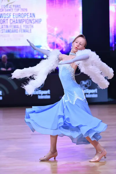 Dancesport competitor: Female dancer: light blue ballroom dress with silver embellishments and a flowin