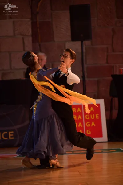 Dancesport competitor: Male dancer: black waistcoat, white long-sleeved shirt, and black trousers