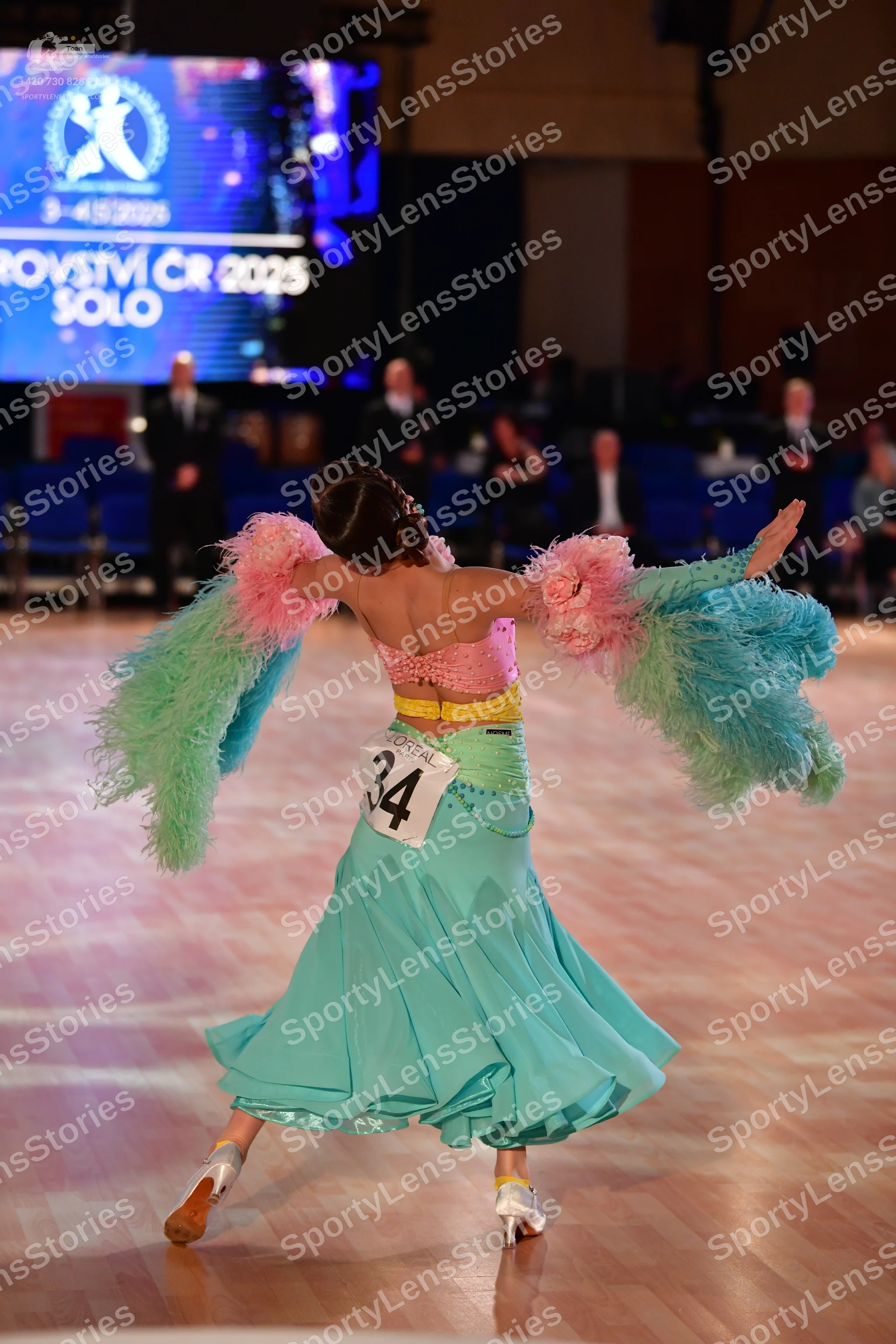 Dancesport competitor #34: Female dancer: light blue ballroom gown with a pink bodice, a yellow waistband, 