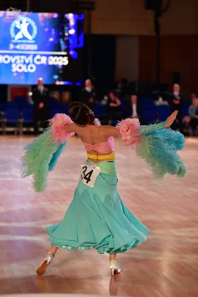 Dancesport competitor #34: Female dancer: light blue ballroom gown with a pink bodice, a yellow waistband, 