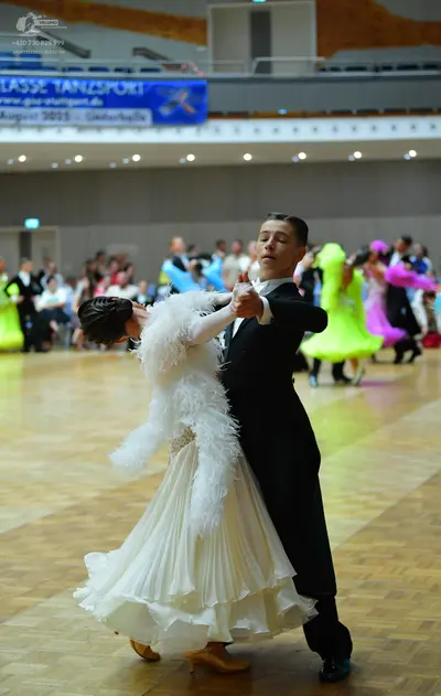 Dancesport competitor: Male dancer: black ballroom tailcoat with a white shirt and white bowtie
