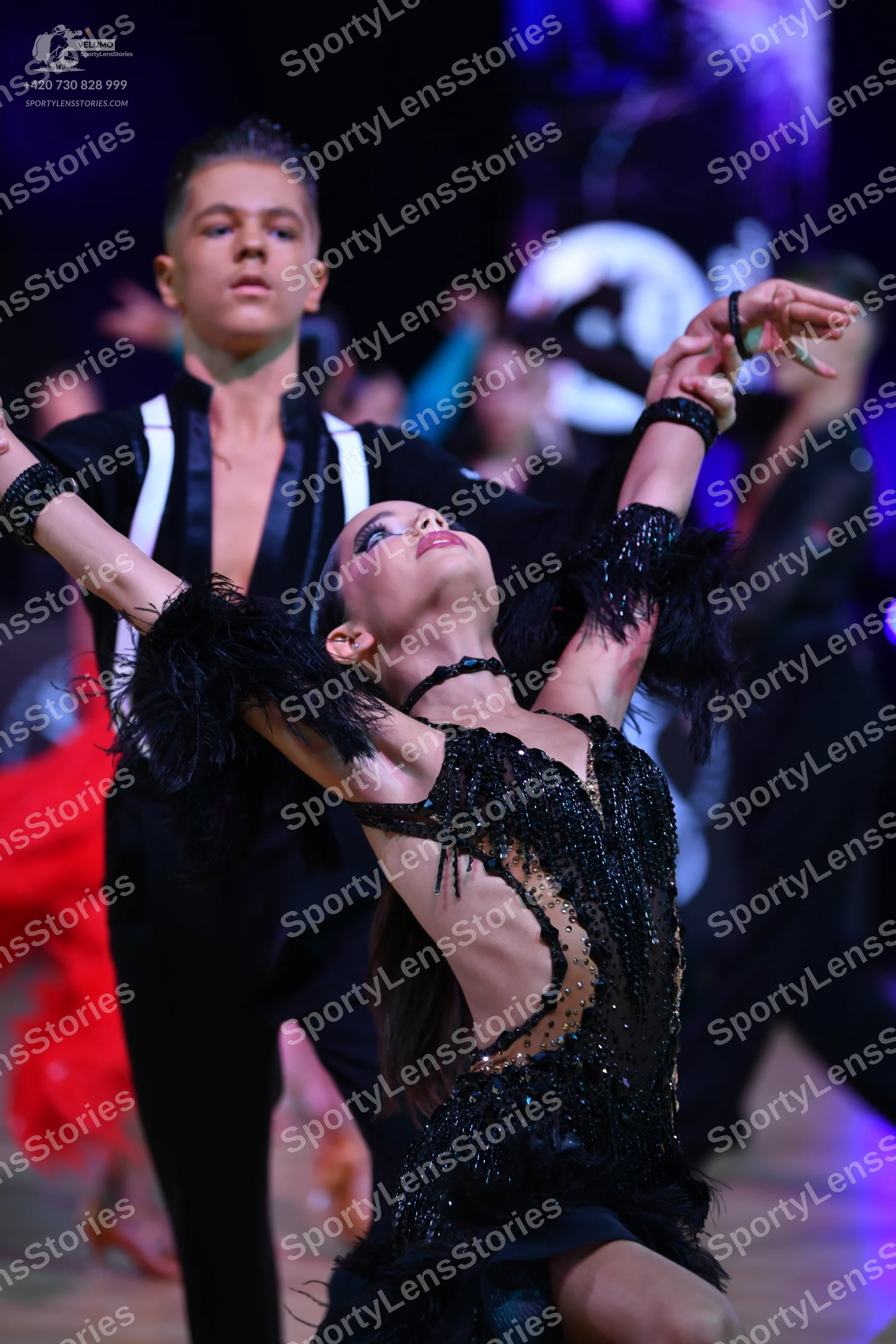 Dancesport competitor: Male dancer: black Latin dance shirt with white/silver satin panels and black tr