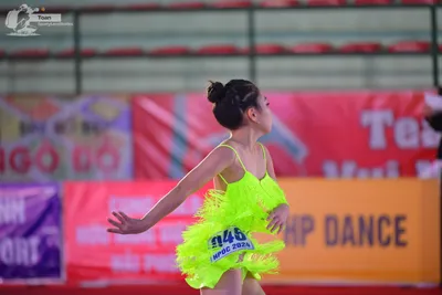 Dancesport competitor #945: ** Red Latin Dress
*   **Color:** Vibrant red
*   **Fabric:** Appears to be a sa