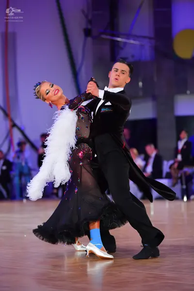 Dancesport competitor: Male dancer: black tailcoat suit with a white shirt and white bow tie