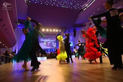 Dancesport competitor: Male dancer (far right): black long-sleeved shirt
