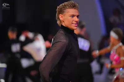 Dancesport competitor: Male dancer: black long-sleeved high-neck top