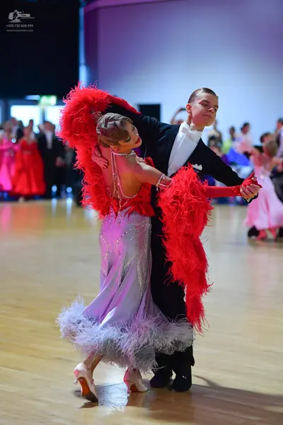 Dancesport competitor: Male dancer: black suit with white shirt and white bow tie