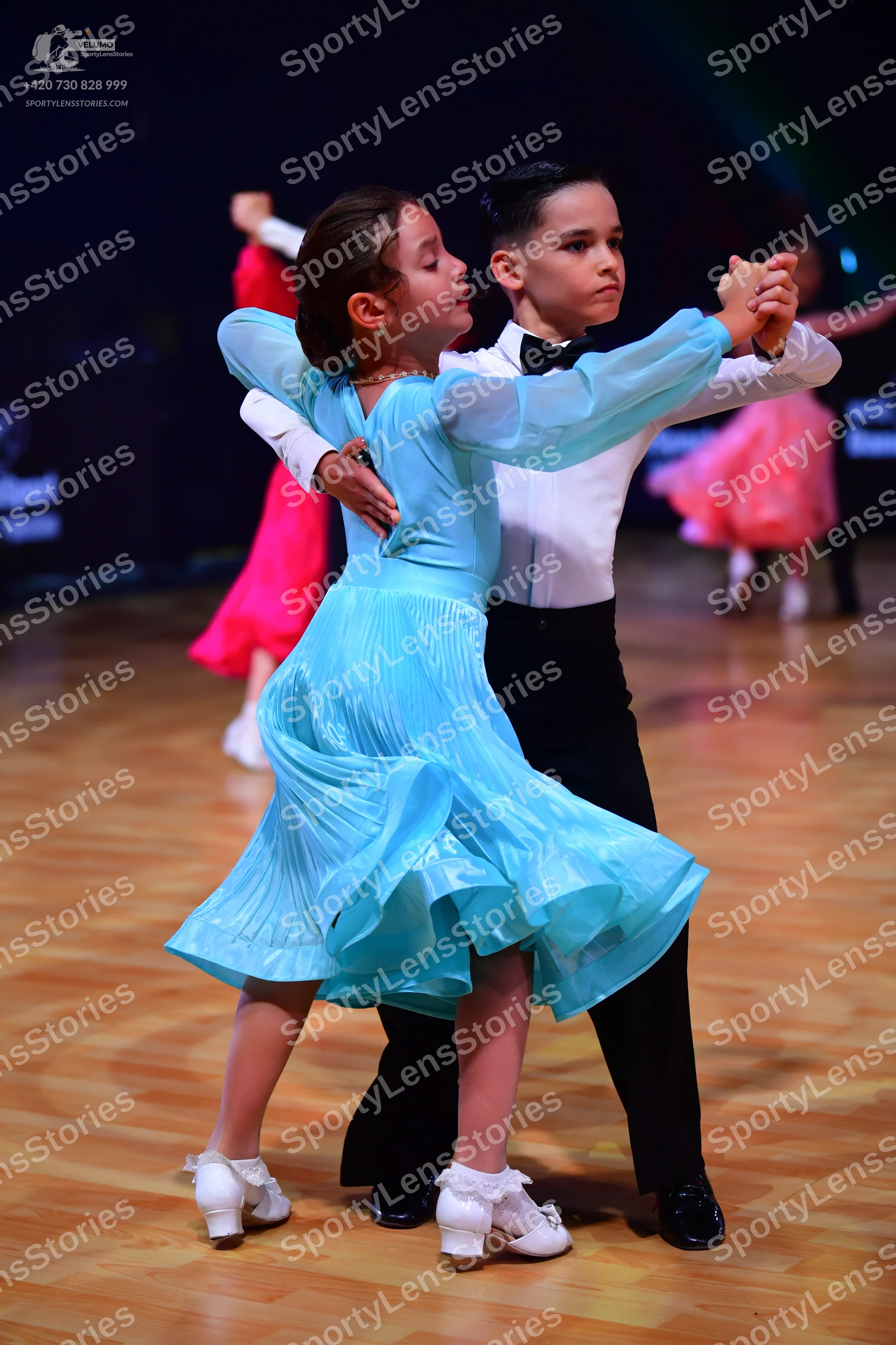 Dancesport competitor: Male dancer: white long-sleeved shirt, black trousers, and a black bowtie