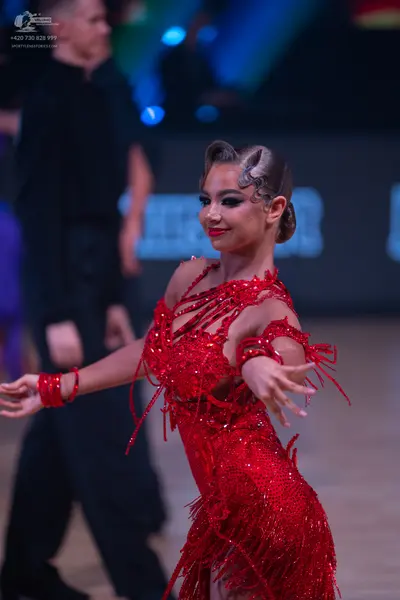 Dancesport competitor: Female dancer: red latin dress with sequins and fringe