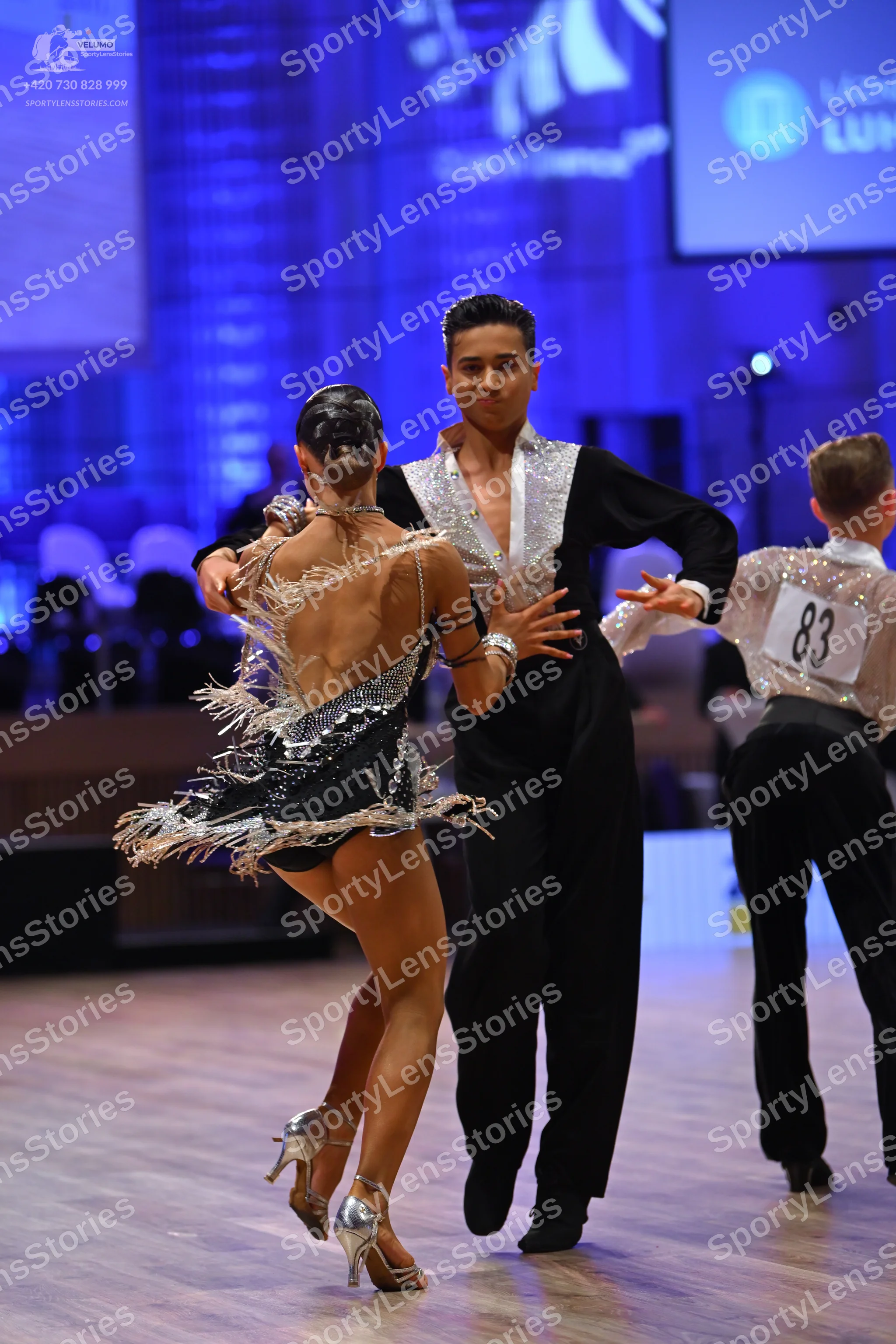 Dancesport competitor: Female dancer: black Latin dance dress with silver sequins and silver fringe