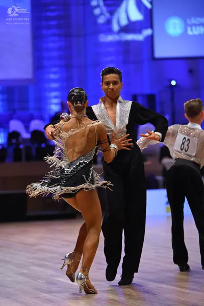 Dancesport competitor: Female dancer: black Latin dance dress with silver sequins and silver fringe