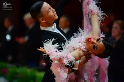 Dancesport competitor: Male dancer: black suit, white shirt, and white bow tie