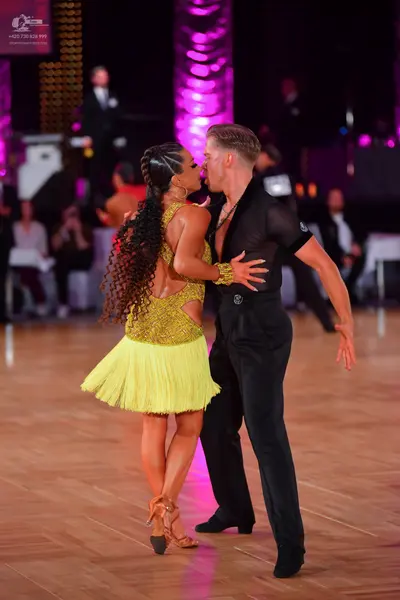 Dancesport competitor: Female dancer: yellow latin dress with a sequined bodice and a fringe skirt