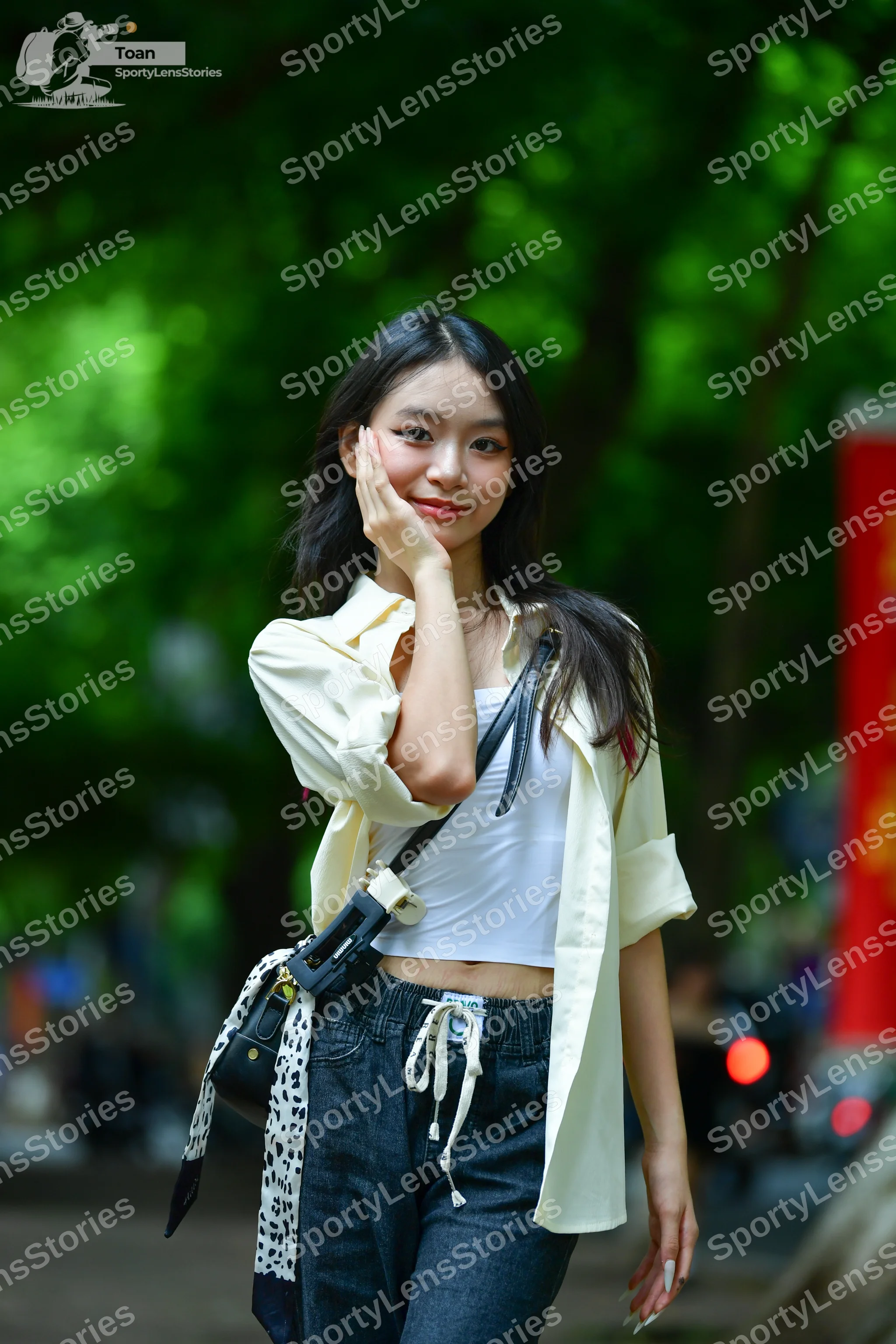 Dancesport competitor: Female dancer: white cropped tank top, off-white unbuttoned long-sleeve shirt, a