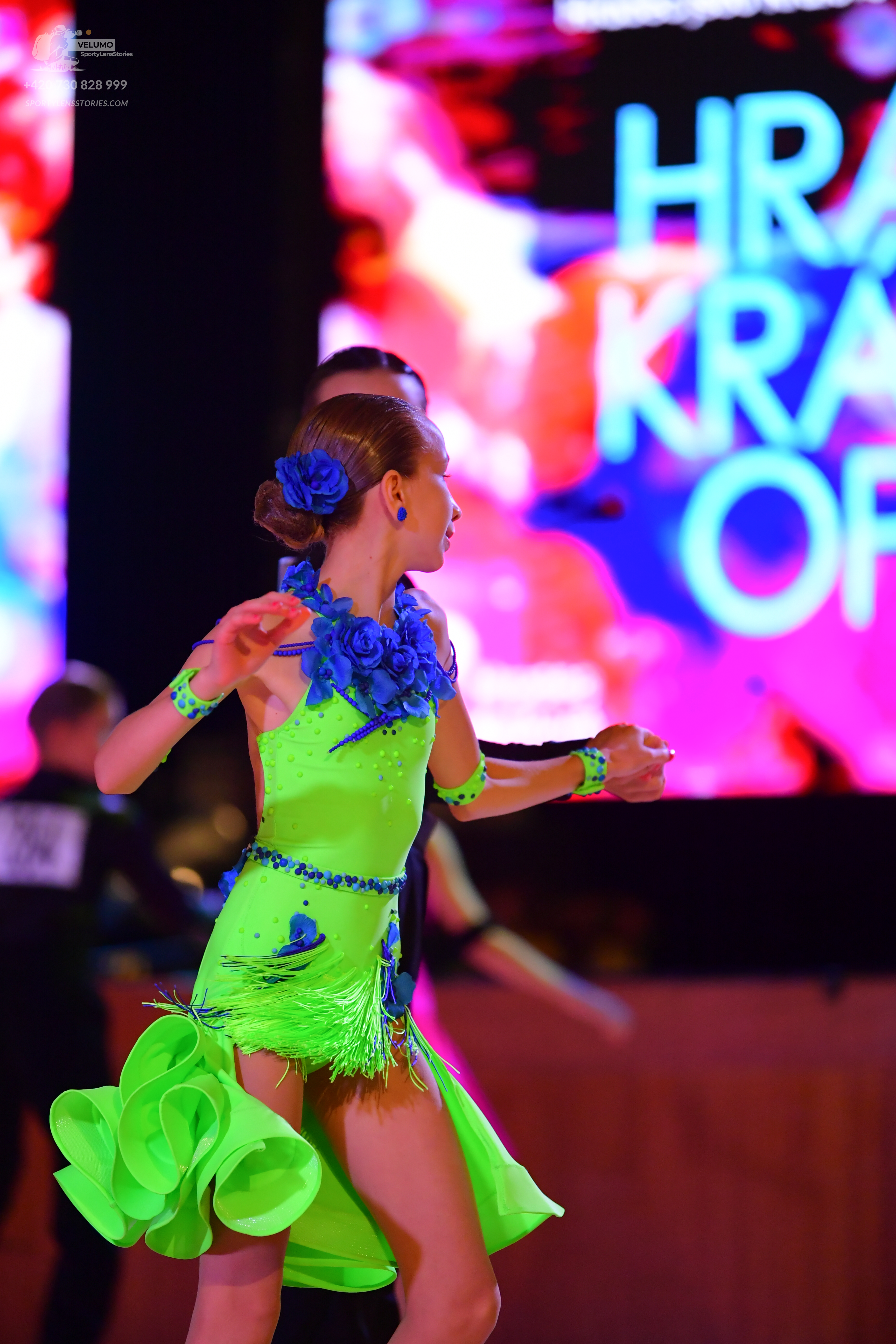 Dancesport competitor: **  Lime green (bright green) latin dress
*   **Fabric:** Appears to be a satin 