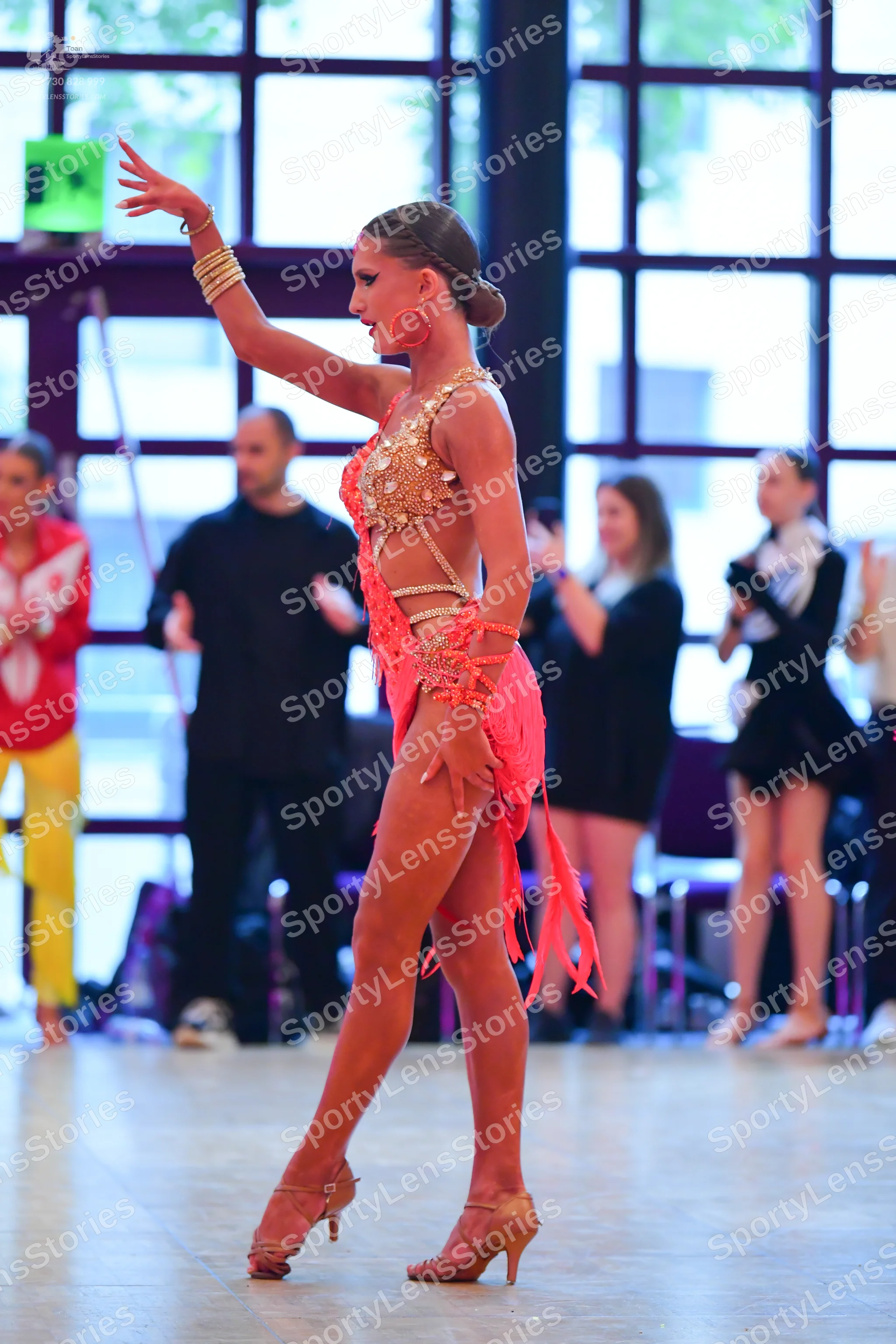 Dancesport competitor: Main dancer: peach-colored Latin dance dress with sequins, cut-outs, and fringe,