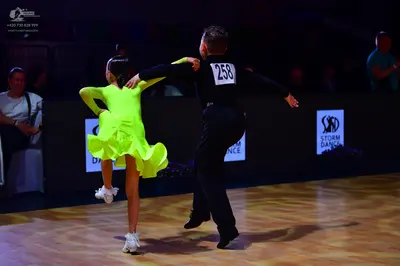 Dancesport competitor: Male dancer: black long-sleeved shirt and black trousers