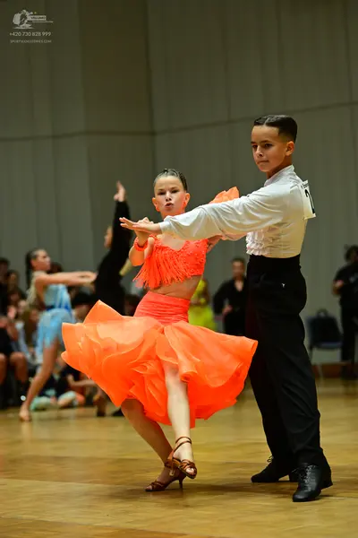 Dancesport competitor: Male dancer: white long-sleeved shirt and black trousers