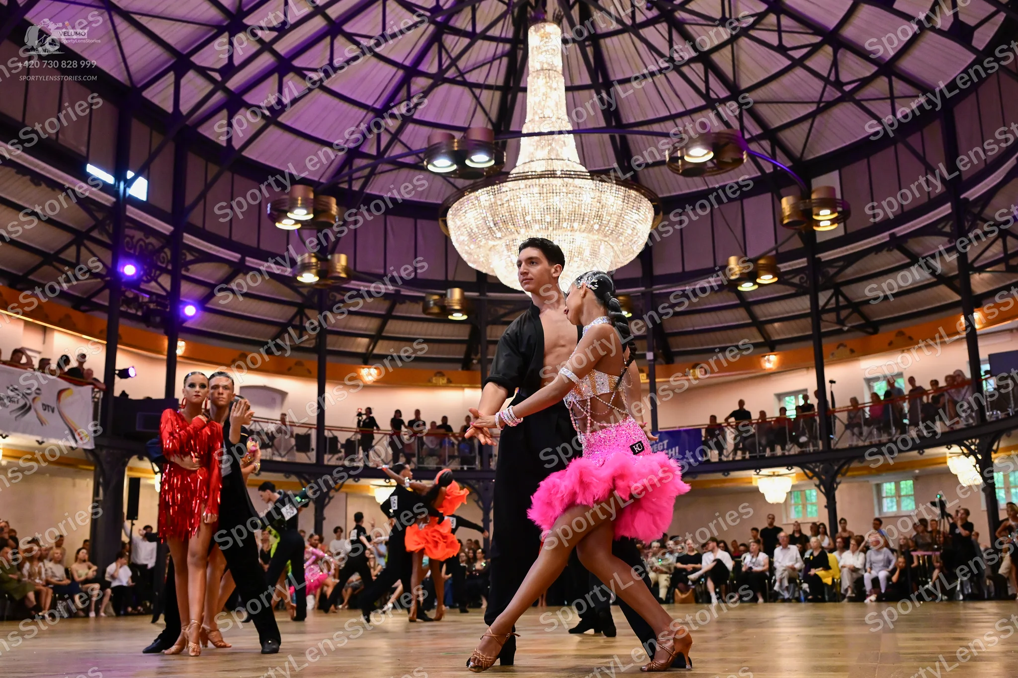 Dancesport competitor: Female dancer (left): red sequin latin dress
