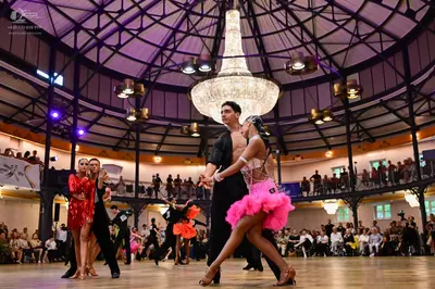 Dancesport competitor: Female dancer (left): red sequin latin dress