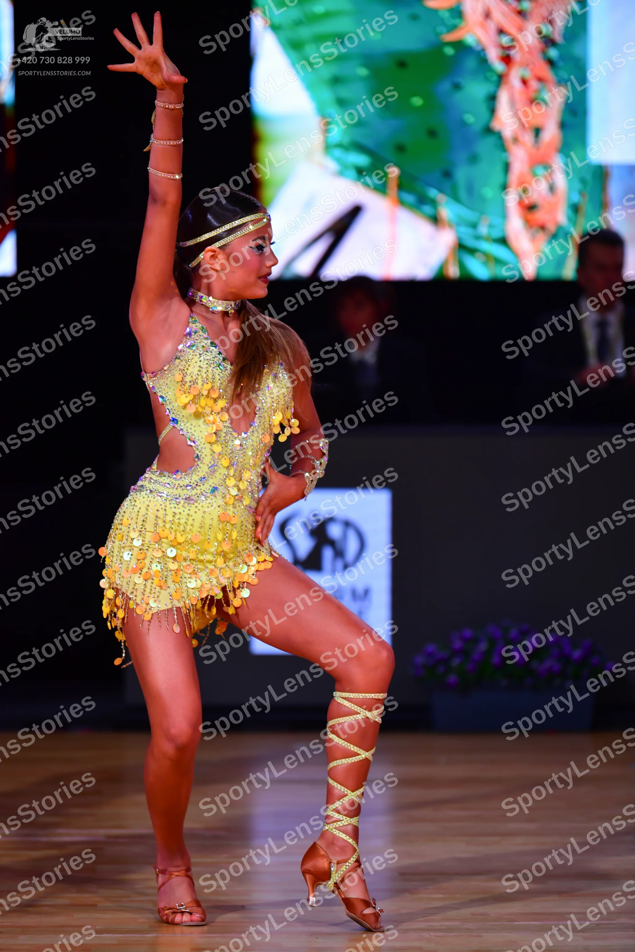 Dancesport competitor: Female dancer: yellow Latin dress with sequins and large paillettes, featuring c
