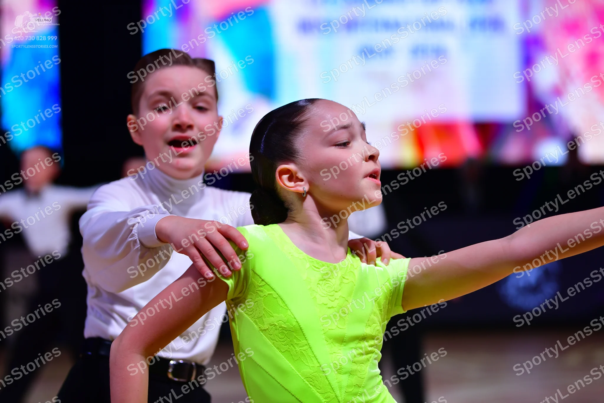 Dancesport competitor: Male dancer: white long-sleeved shirt and black trousers with a black belt