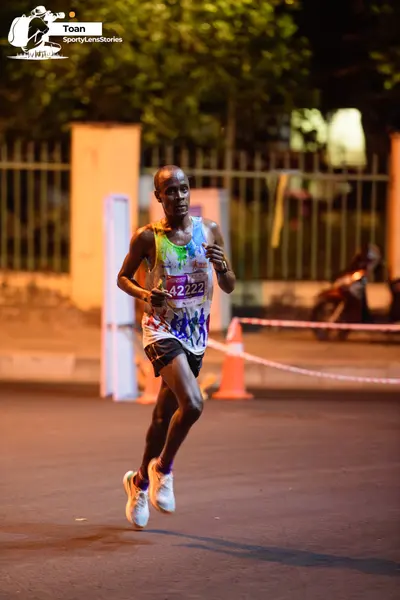 Marathon runner #42222: Runner 1: colorful patterned tank top, dark shorts, white shoes