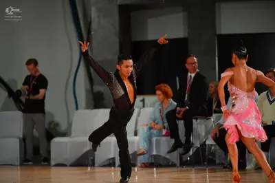 Dancesport competitor: Male dancer: black long-sleeved shirt with sequin detailing on the chest/front a