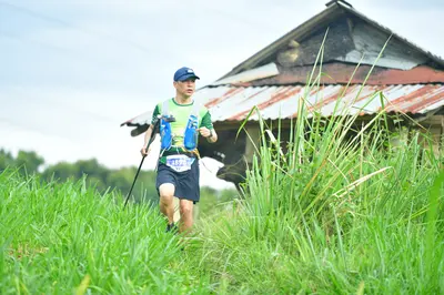 Marathon runner: Runner 1: green and white jersey, dark blue shorts, blue hydration vest, dark bl