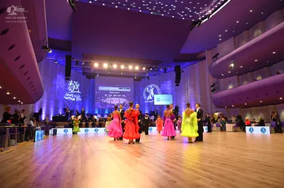 Dancesport competitor: Female dancers: lime green, pink, red, and yellow ballgowns made of smooth, sati