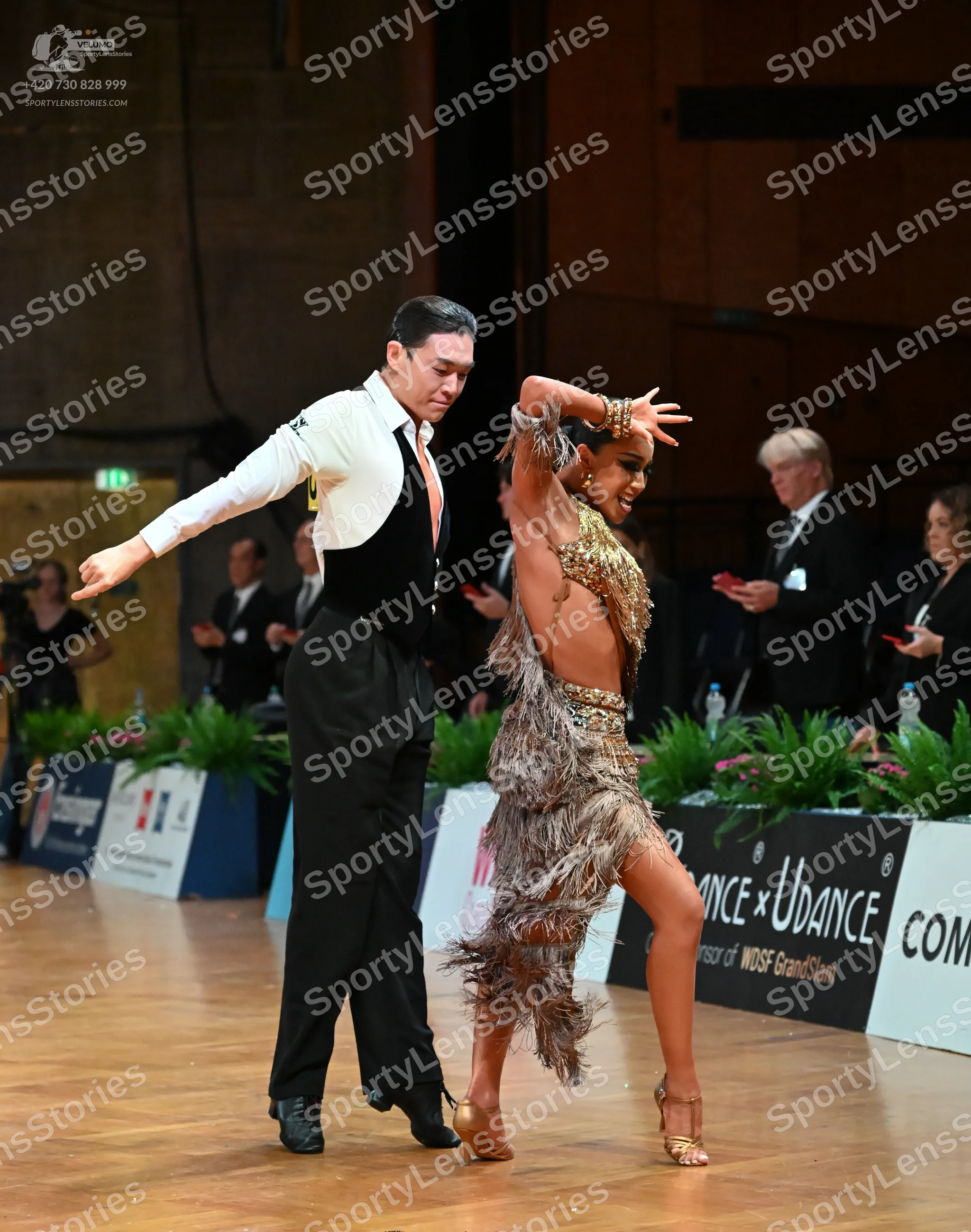 Dancesport competitor: Male dancer: white long-sleeved shirt, black waistcoat, and black trousers