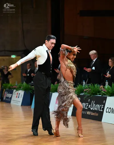 Dancesport competitor: Male dancer: white long-sleeved shirt, black waistcoat, and black trousers