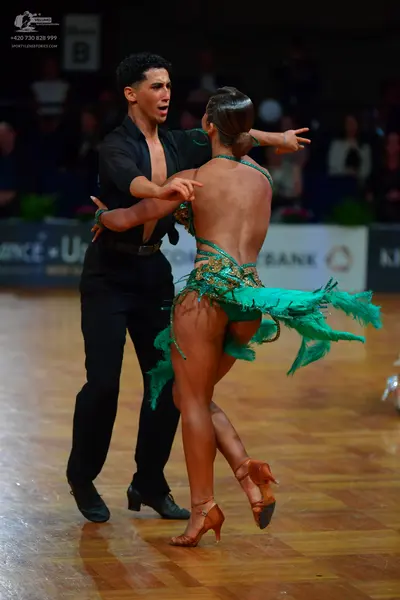 Dancesport competitor: Male dancer: black long-sleeved shirt and black trousers