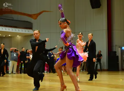Dancesport competitor: Male dancer: black long-sleeved shirt and black trousers