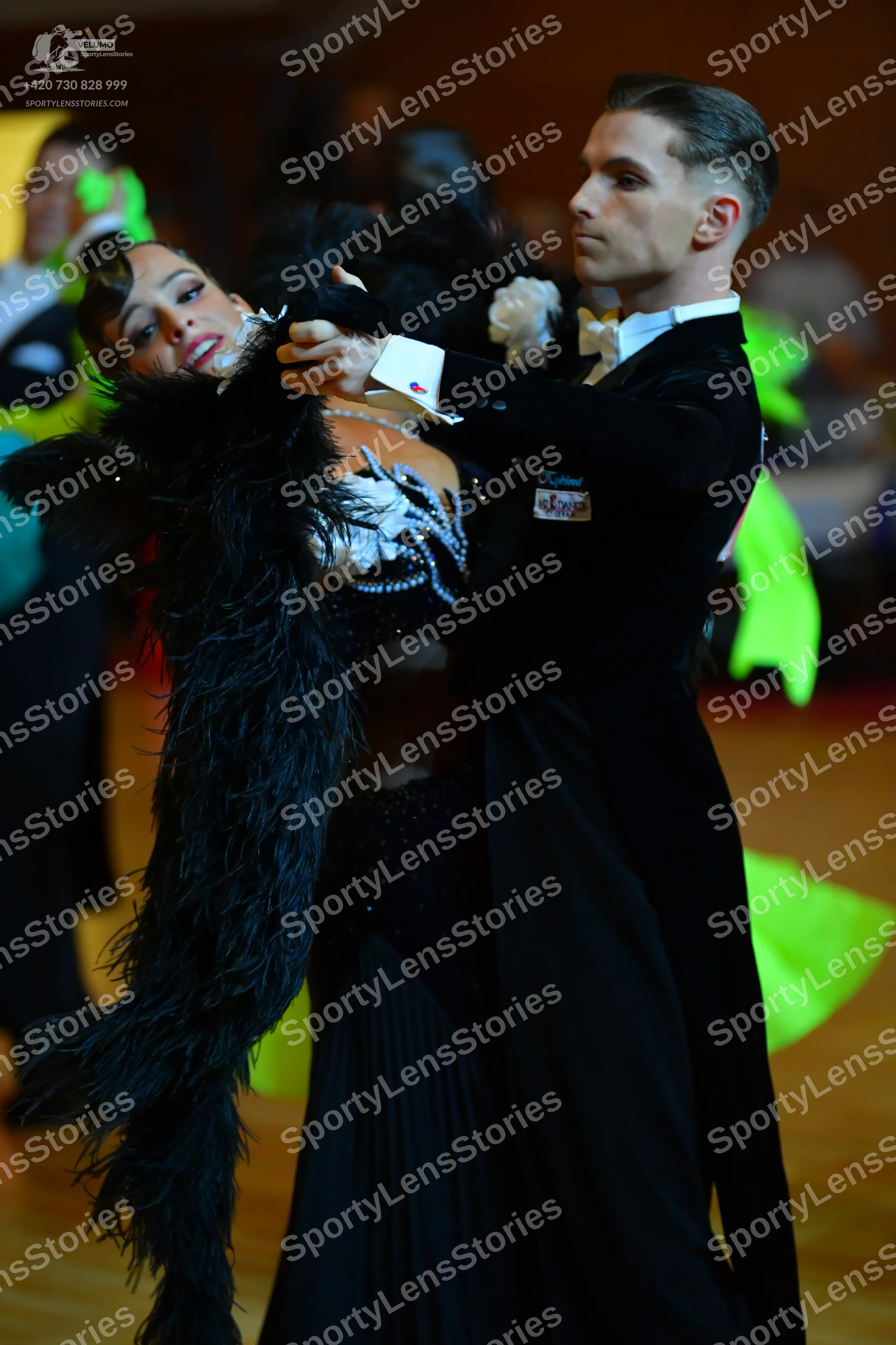 Dancesport competitor: ** Black tailsuit
*   **Fabric:** Sequined
*   **Style:** Tailsuit (a classic ba