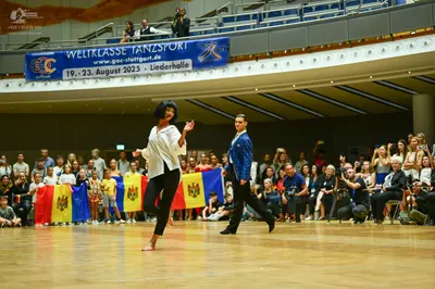 Dancesport competitor: Female dancer: white long-sleeved blouse and black leggings