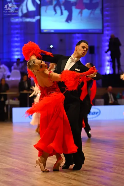 Dancesport competitor: Male dancer: black suit with a white shirt and white bow tie