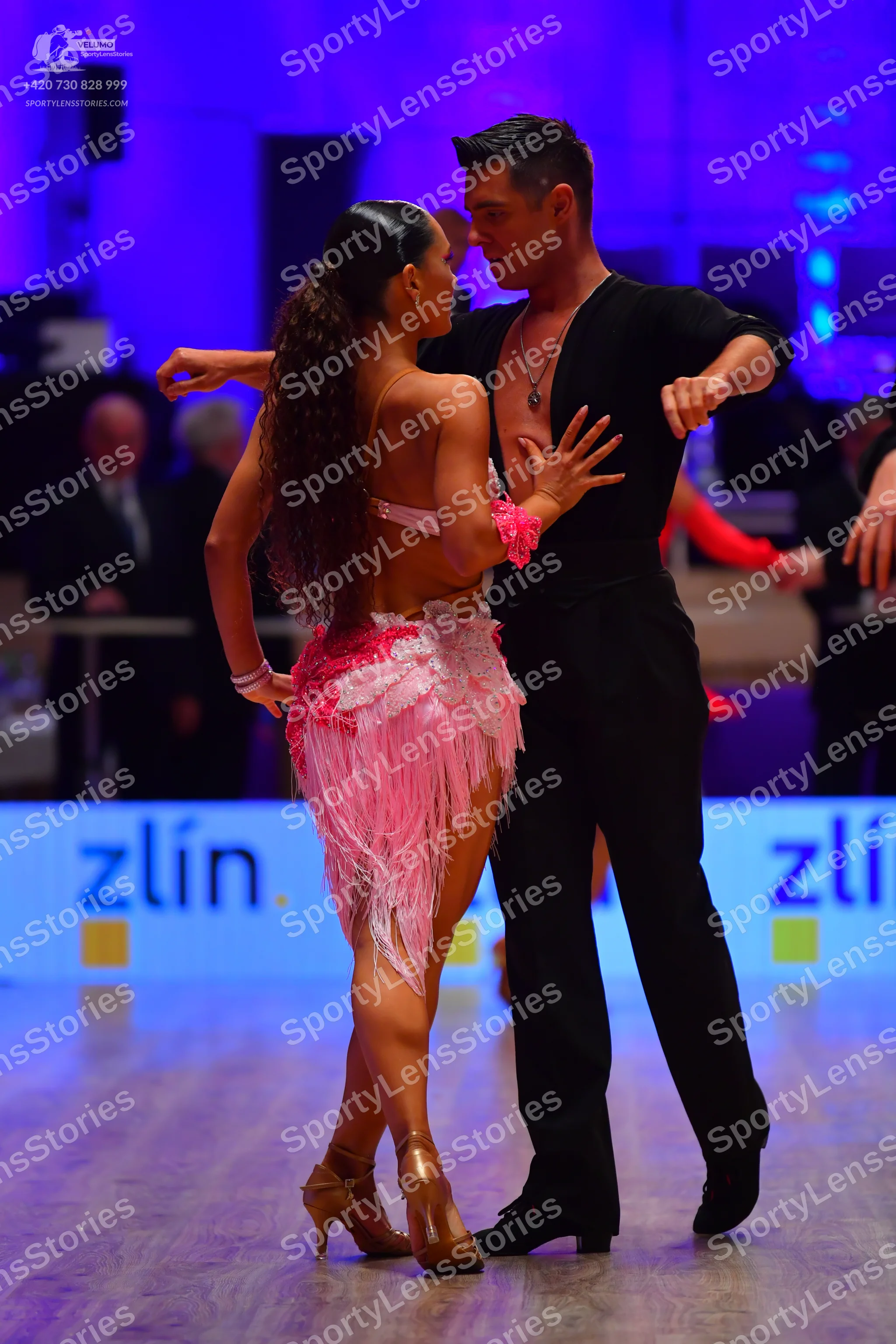 Dancesport competitor: Female dancer: pink latin dress with fringe and sequin details, gold strappy dan