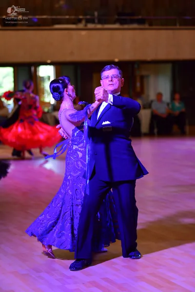Dancesport competitor: Male:** Black tailsuit with silver sequin lapels and matching trousers
