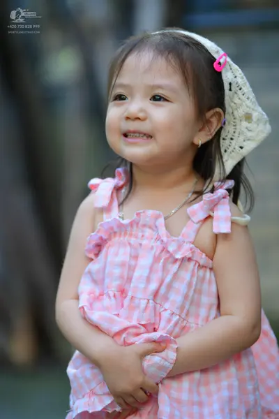 Dancesport competitor: Female dancer: pink and white gingham pattern sleeveless dress with ruffled shou