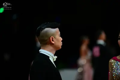 Dancesport competitor: Male dancer: black suit with a white shirt and white bow tie